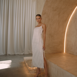 White low back maxi dress with tassels all over the dress & strap and a side split | Gina Kim
