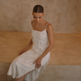 White low back maxi dress with tassels all over the dress & strap and a side split | Gina Kim
