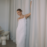 White low back maxi dress with tassels all over the dress & strap and a side split | Gina Kim