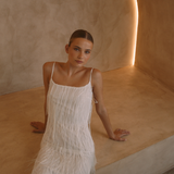 White low back maxi dress with tassels all over the dress & strap and a side split | Gina Kim