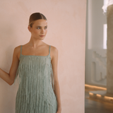 Sage colour backless maxi dress with tassels all over the dress & strap and a side split | Gina Kim