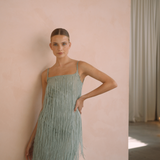 Sage colour backless maxi dress with tassels all over the dress & strap and a side split | Gina Kim