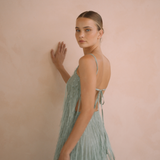 Sage colour backless maxi dress with tassels all over the dress & strap and a side split | Gina Kim