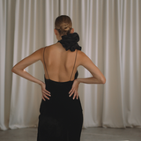 Woman wearing a black velvet dress with floral neck choker from the back | Gina Kim