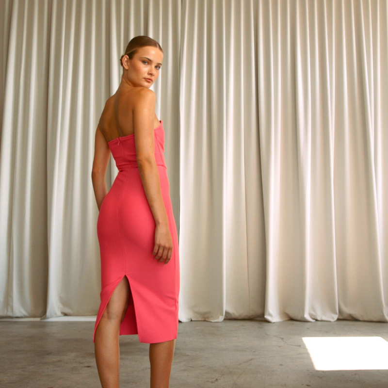 Strapless solid hot pink coloured mid-calf length dress, from the back  | Gina Kim