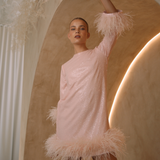 A round neckline pink sequin mini dress with ostrich feathers around the 3/4 sleeves and the skirt hemline | Gina Kim