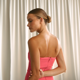 Strapless solid hot pink coloured mid-calf length dress, from the back  | Gina Kim
