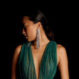 Woman wearing a pair of rhinestone long chain dangle earrings | Gina Kim